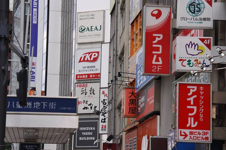 A photo displaying various Japanese signs that advertise sarakin loan companies.